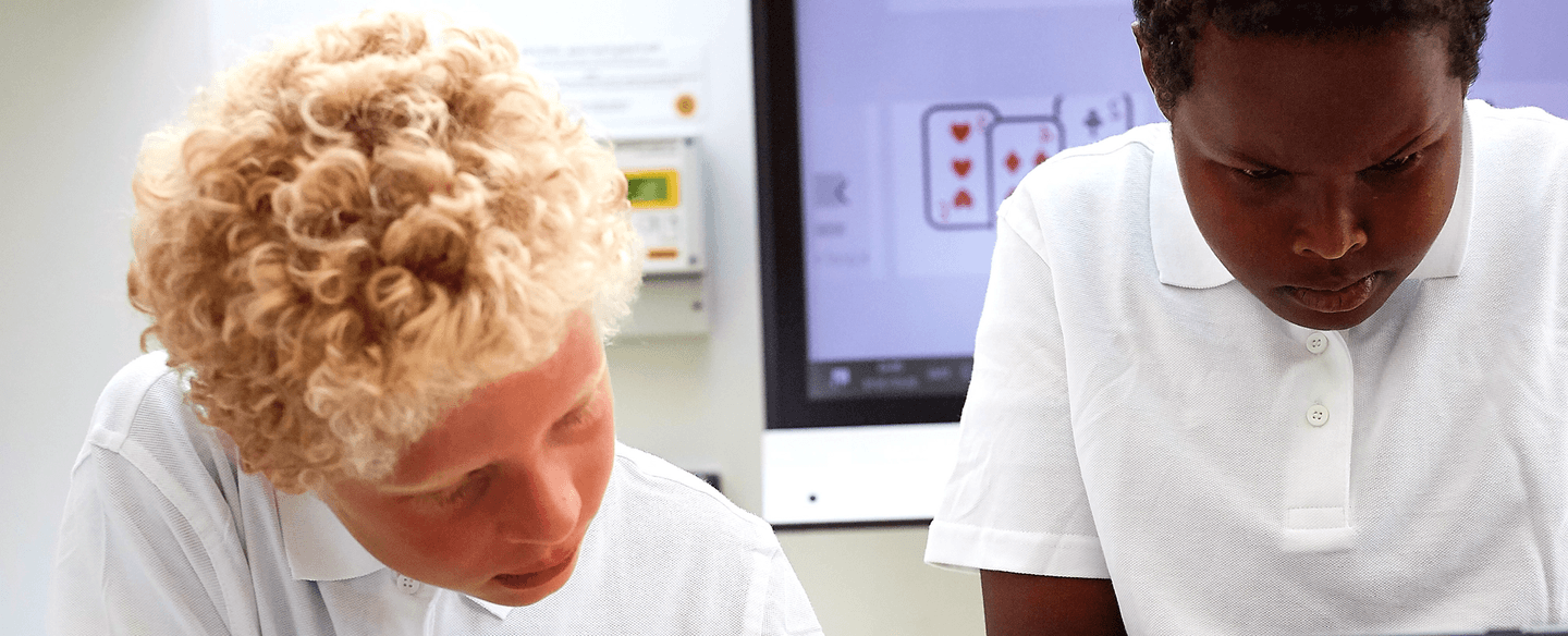 two boys concentrating on work in class