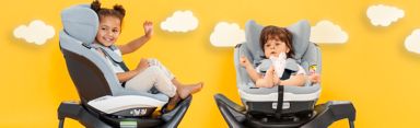 Two children sitting happily in their car seats