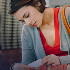 Photo of a woman checking the price tag in a retail store