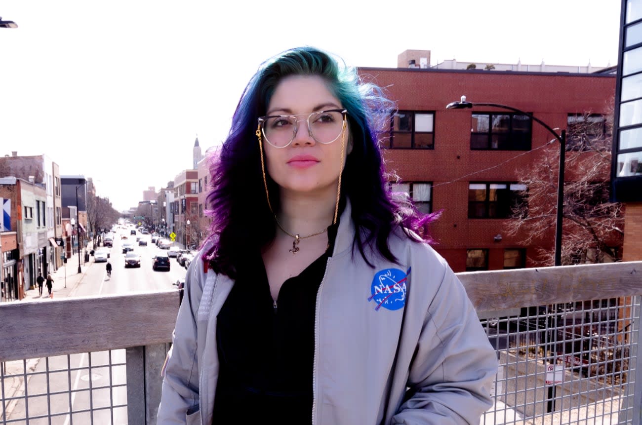 Photo of Lorena Mesa downtown on a pedestrian overpass.