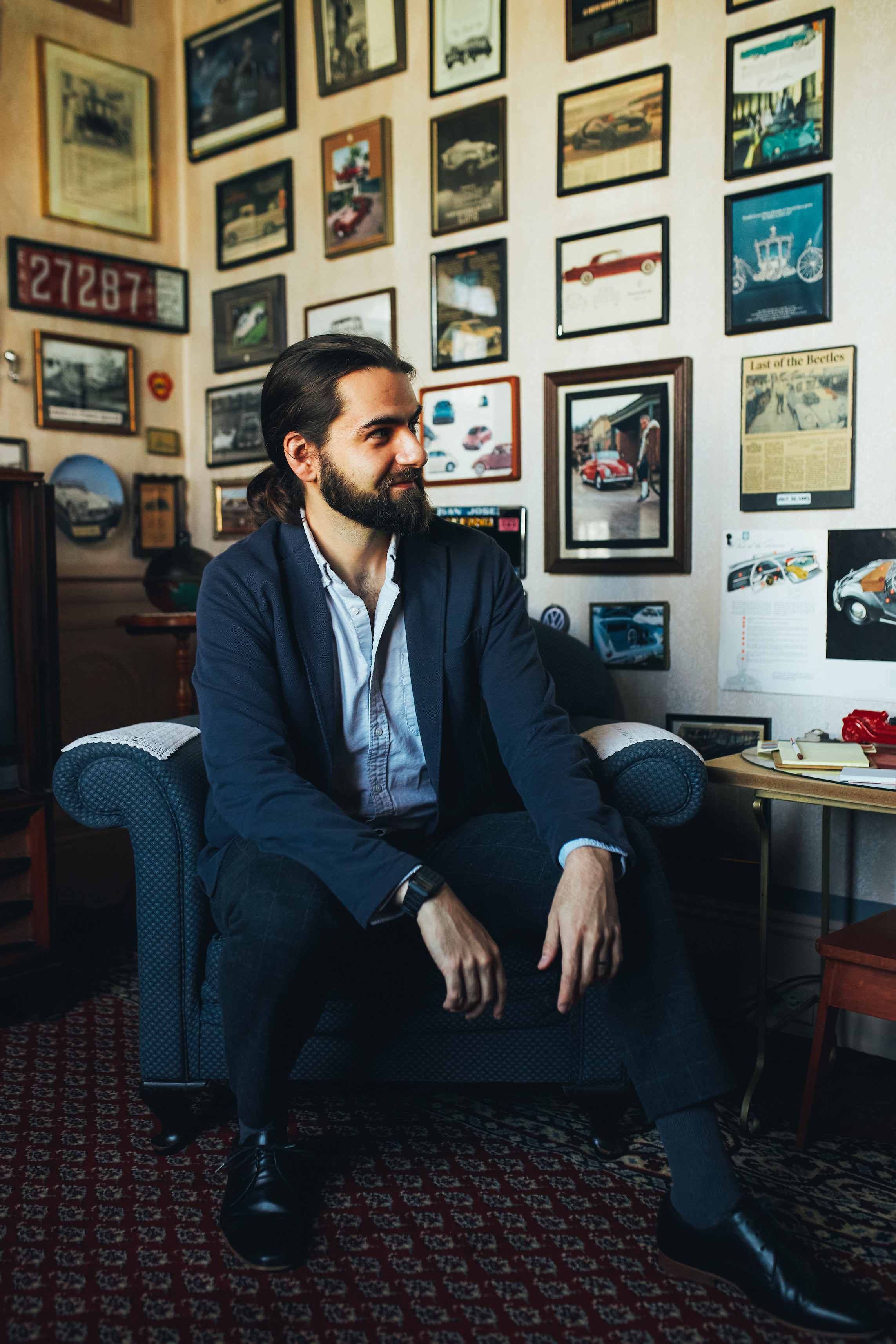 Author Mahmoud sitting in a chair in a photo-covered office