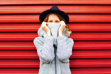 Woman pulling turtleneck up to cover her face