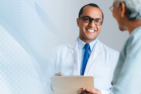 Board-certified dermatologist, an FAAD, cheerfully talking with patient