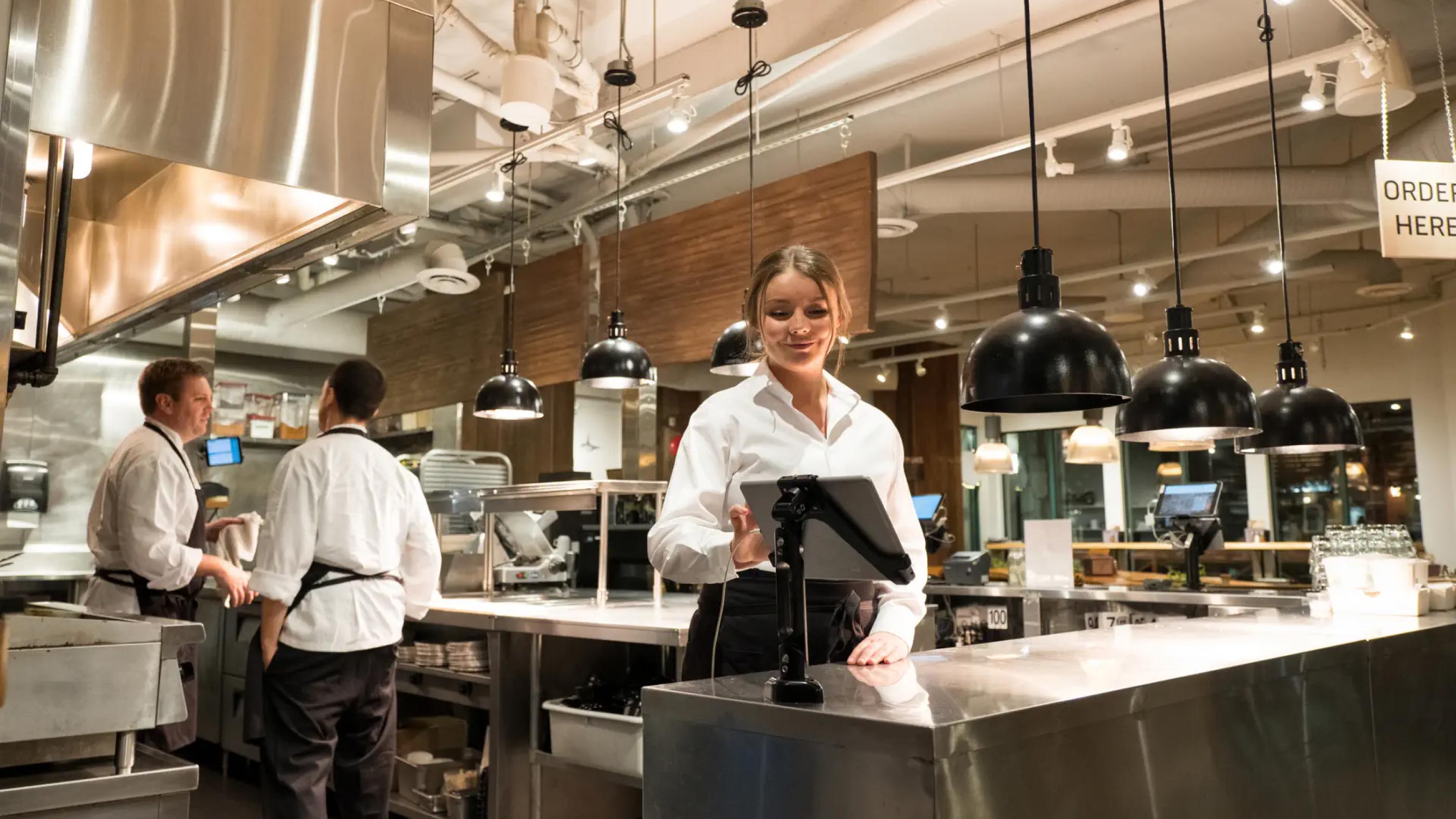 Caterer using tablet in kitchen