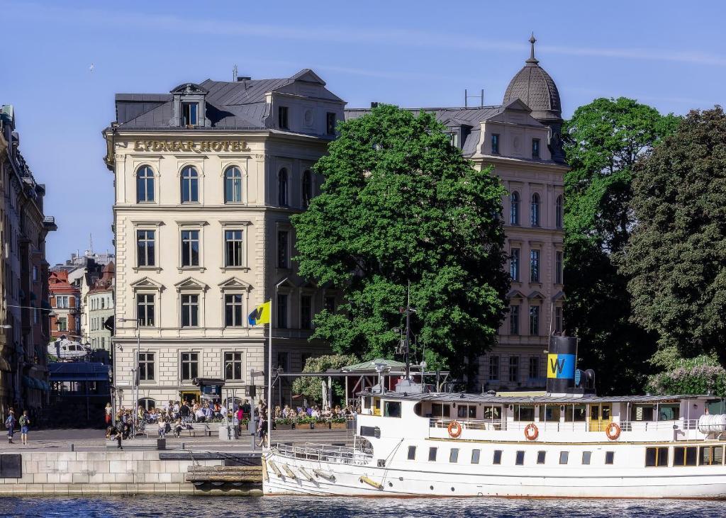 a boat in the water in front of a building at Lydmar Hotel in Stockholm