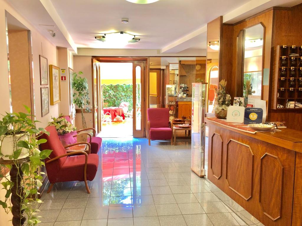 a kitchen with red chairs and a dining room at Hotel Signa in Perugia