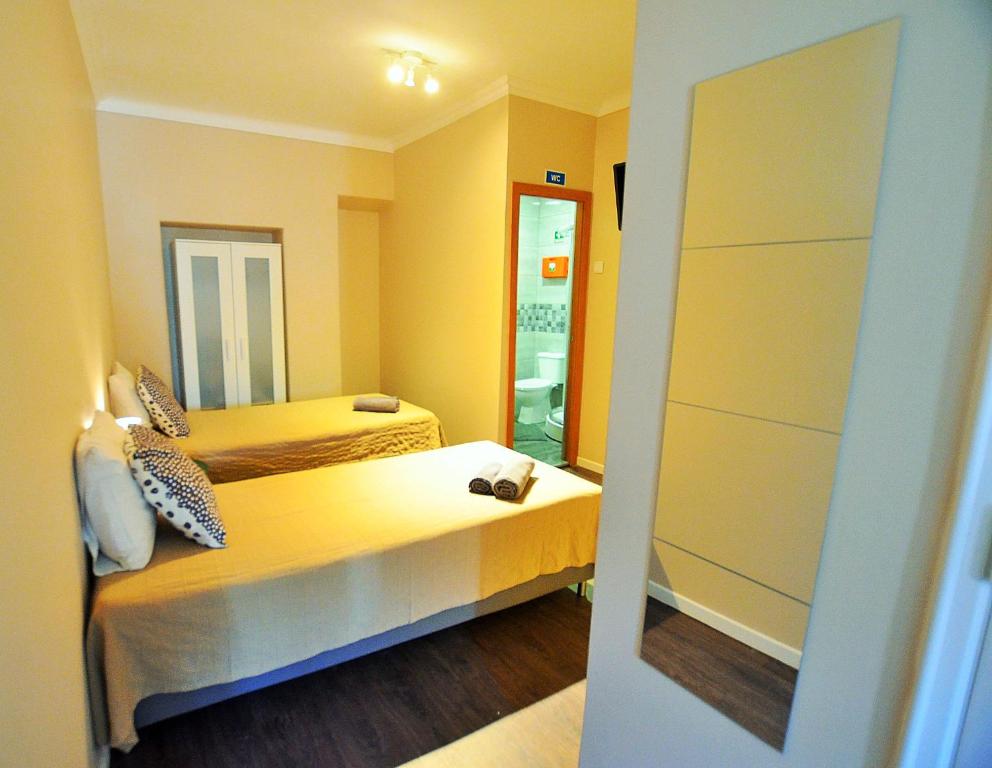 Ένα ή περισσότερα κρεβάτια σε δωμάτιο στο Rooms DP Setúbal