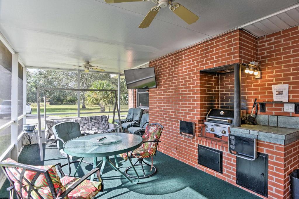 a patio with a table and chairs and a brick wall at Sandford Vacation Rental Near Airport and Lake! in Sanford