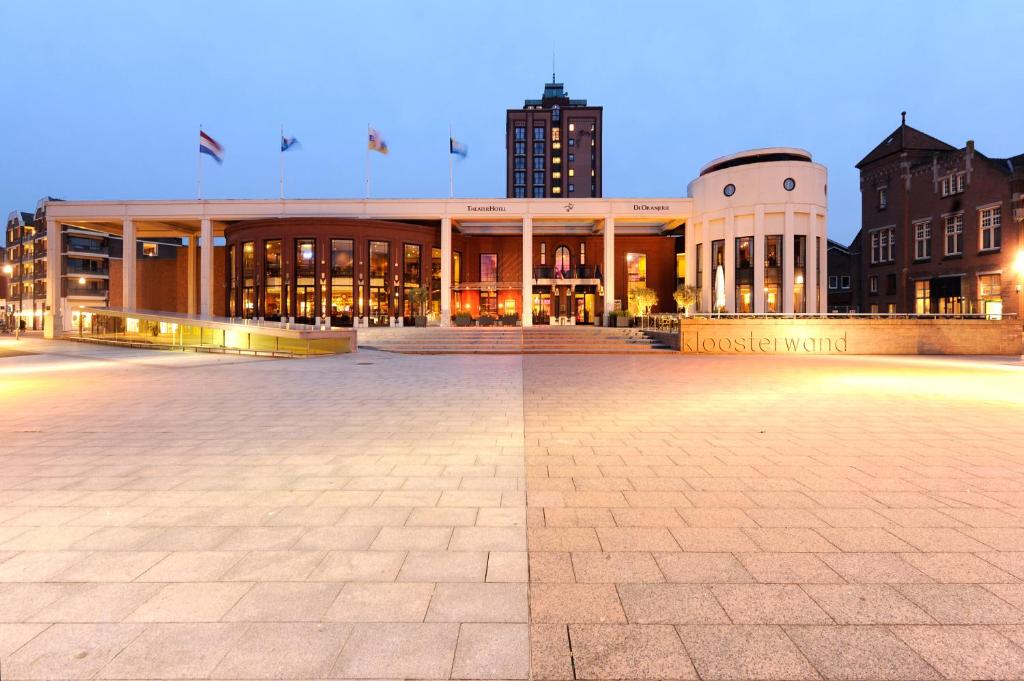 un grande edificio in una città di notte di Van der Valk TheaterHotel De Oranjerie a Roermond