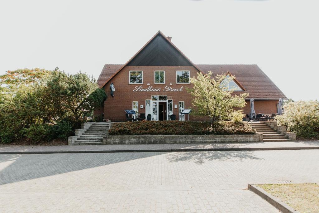 a house with a sign on the front of it at Landhaus Streeck in Rüggow