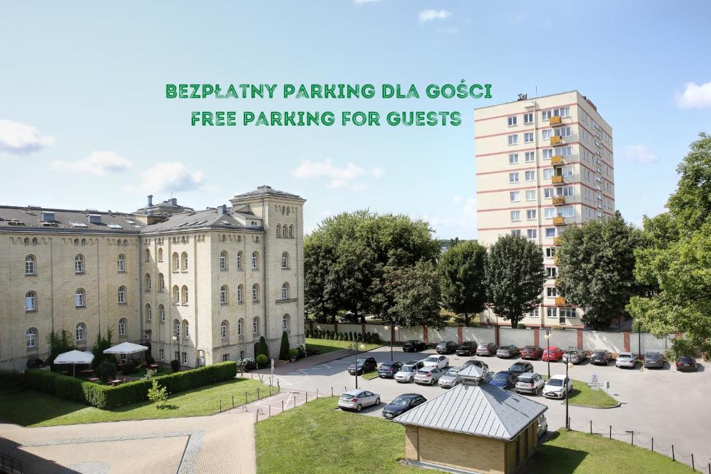 a large building with cars parked in a parking lot at Dom Muzyka in Gdańsk