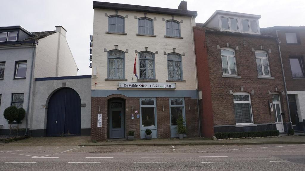 a building on the corner of a street at Hotel De Wilde Kriek - before De Karsteboom in Valkenburg