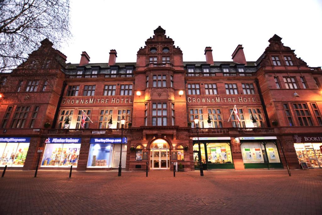 a large brick building with a lot of windows at Crown & Mitre Hotel in Carlisle