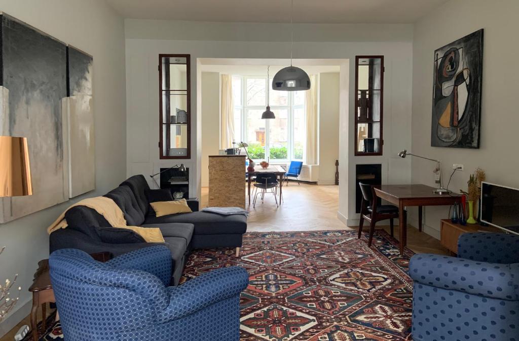 a living room with a blue couch and blue chairs at HS68-apartment in Maastricht