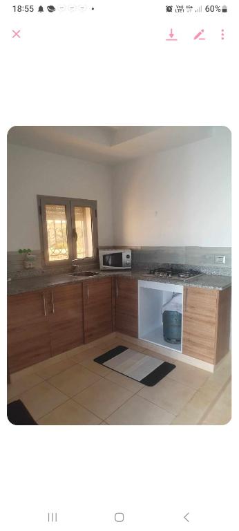 a kitchen with a counter top and a microwave at Residence djerba 4 in Houmt Souk