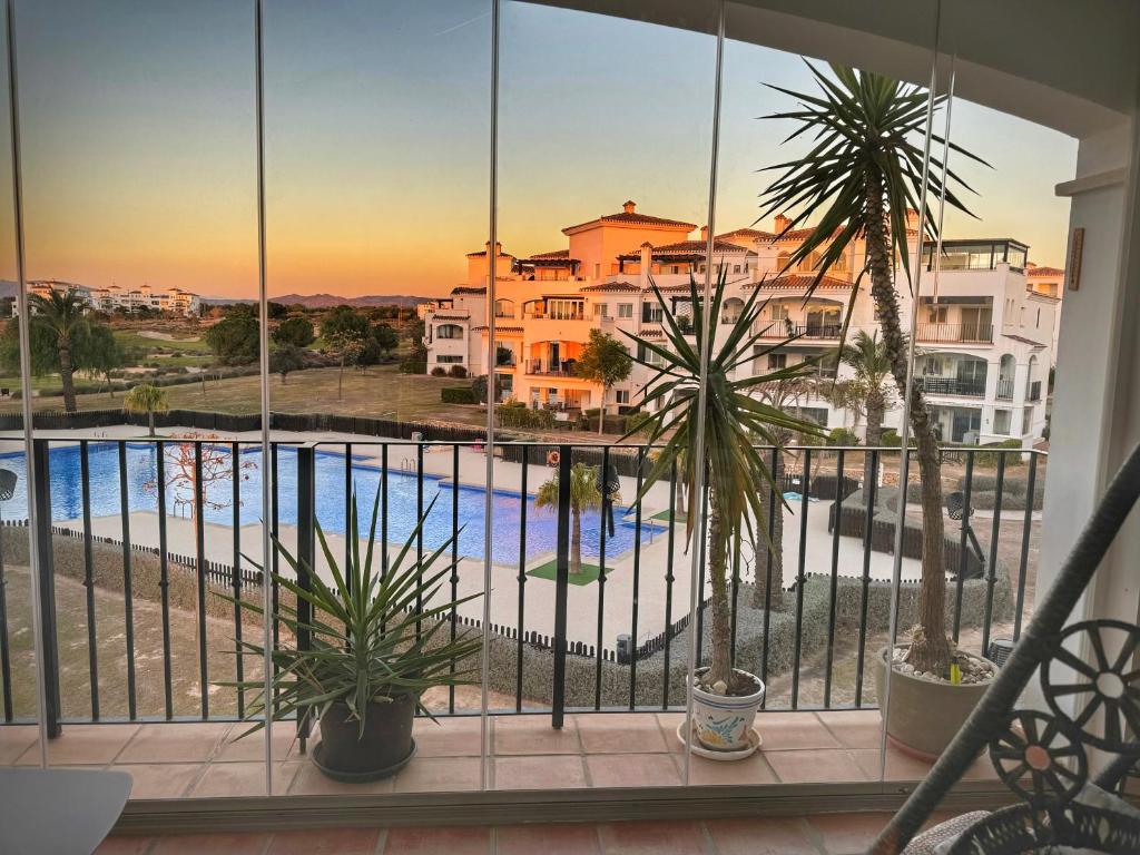 a balcony with a view of a pool and buildings at Romantik M in Sucina