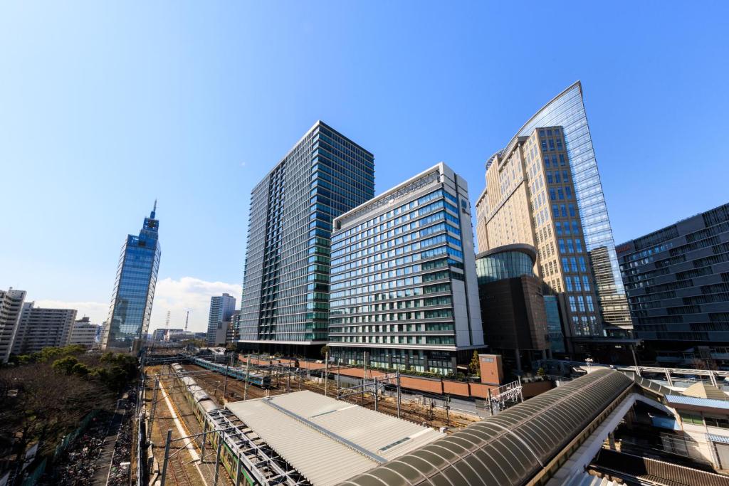 a group of tall buildings in a city at HOTEL METROPOLITAN KAWASAKI in Kawasaki