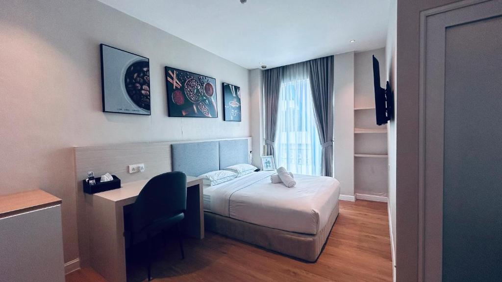 Tempat tidur dalam kamar di AP Concept Hotel