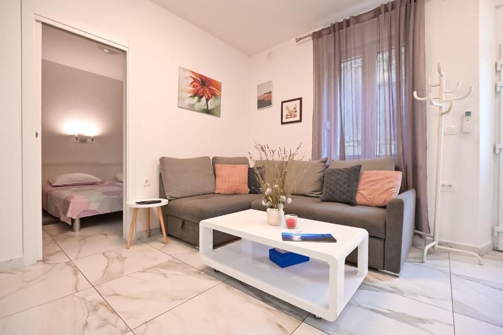 a living room with a couch and a table at Vista Apartment in Opatija