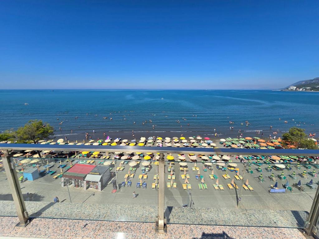 a view of a beach with a bunch of umbrellas at Roxhensi 2 in Shëngjin