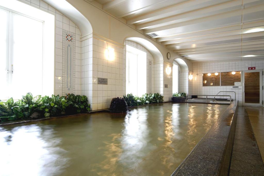 un gran pasillo con una piscina de agua en un edificio en Hotel Monterey Sendai, en Sendai