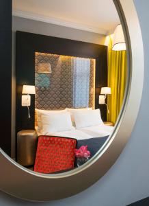 a hotel room with a bed and a mirror at Thon Hotel Spectrum in Oslo