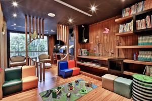 a childrens room with a library with bookshelves at Hotel Sukimi in Tainan