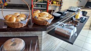 two baskets of bread on a counter in a kitchen at Lord Hotel Camburi in Vitória