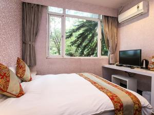 a bedroom with a bed with a window and a television at Courier Station in Wulai