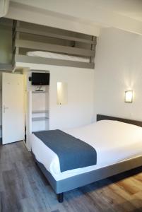 Una cama o camas en una habitación de Aerel Hotel Aéroport Blagnac