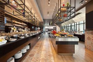 un restaurante con una línea de buffet con comida a la vista en Ramada by Wyndham Manama City Centre, en Manama