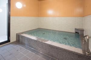 a jacuzzi tub in a bathroom at Kuretake-Inn Hamamatsueki Minamiguchi Premium in Hamamatsu