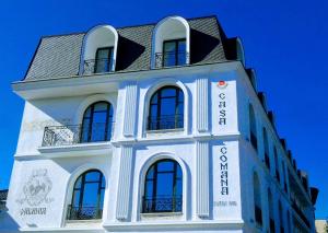 a white building with a black roof at Casa Comana Boutique Hotel in Bucharest