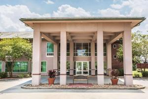 a gazebo in front of a building at Ramada by Wyndham Luling in Luling