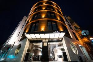 a building with a round tower at night at mOdus Hotel in Varna City