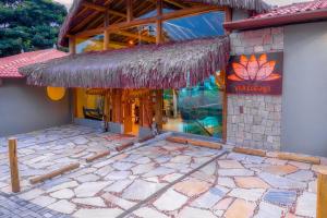 a building with a sign on the side of it at Hotel Vila Kebaya in Ilhabela