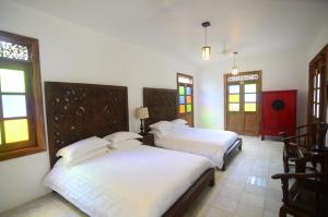 מיטה או מיטות בחדר ב-Lanna Ban Hotel