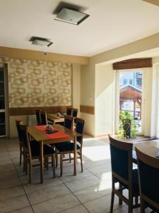 a dining room with a table and chairs at Hotel Orlan in Bratislava