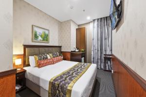 Posteľ alebo postele v izbe v ubytovaní YEHS Hotel Sydney CBD