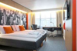 a hotel room with a bed and a desk at Thon Hotel Bergen Airport in Bergen