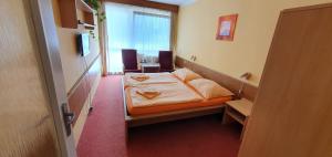 Cama ou camas em um quarto em Hotel Poprad