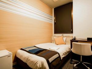 A bed or beds in a room at Hotel AreaOne Nobeoka