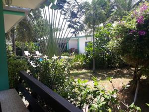 a bench in a garden with flowers and plants at Sunya Cottage in Lamai