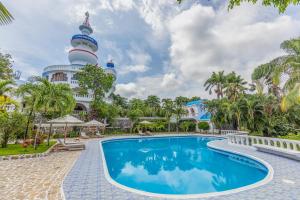 a swimming pool in front of a building at Nosara Beach Hotel in Nosara