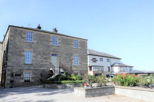 a large brick building with a white house at The Mansefield Hotel in Elgin