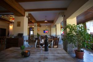 a dining room with a table with a bottle of wine at Family Prim Hotel in Sandanski