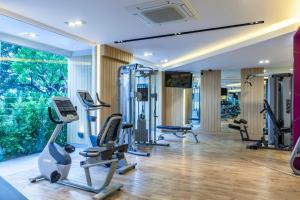 een fitnessruimte met loopbanden en crosstrainers bij Pacific Park Hotel in Si Racha