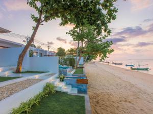 ein Haus am Strand mit Treppen und Bäumen in der Unterkunft White Whale Beachfront Pool Villa in Ban Bang Po