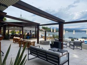 a patio with furniture and a view of the water at Hotel Savoy in Opatija