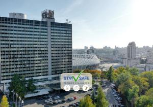 a large truck in a parking lot in front of a building at Premier Hotel Rus in Kyiv